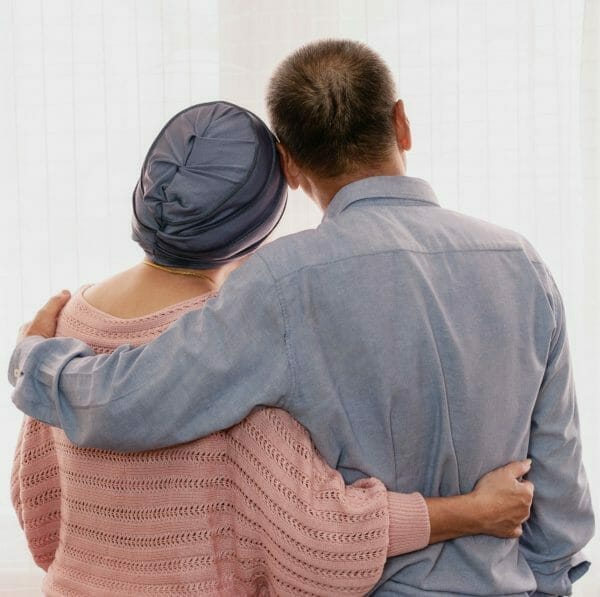 couple holding each other after getting a viatical settlement for Esophageal Cancer