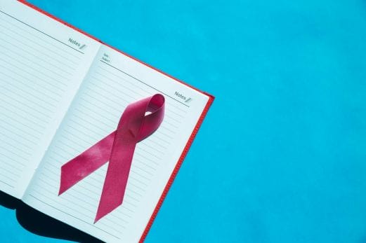 Ribbon cancer sign on notebook