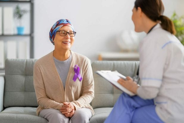 Female cancer patient listening to doctor talk about if stage 4 cancer is curable