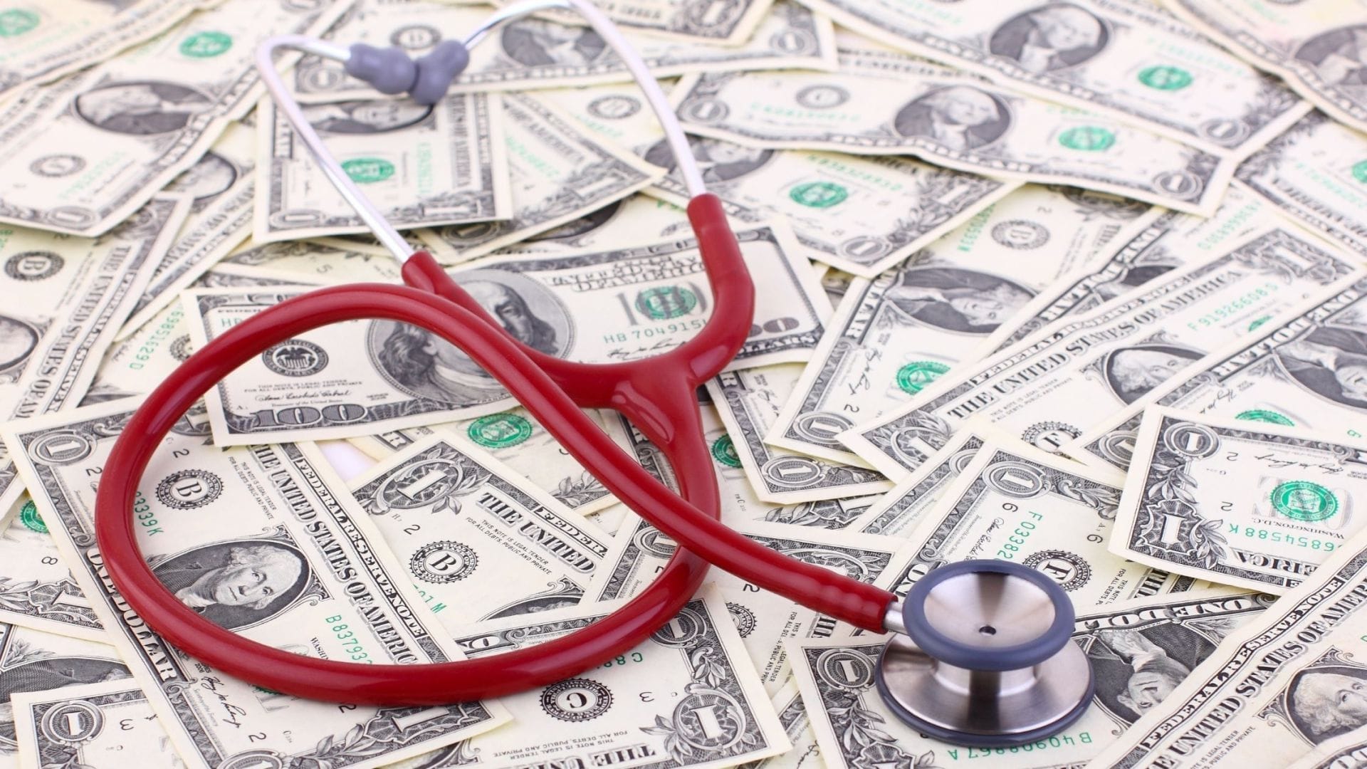 Image of a stethoscope over money 