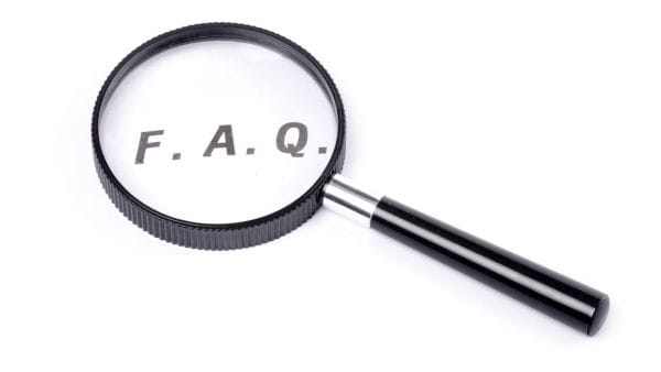 Magnifying glass focused on the text 'F.A.Q.', symbolizing the detailed exploration of frequently asked questions on bladder cancer treatment costs.